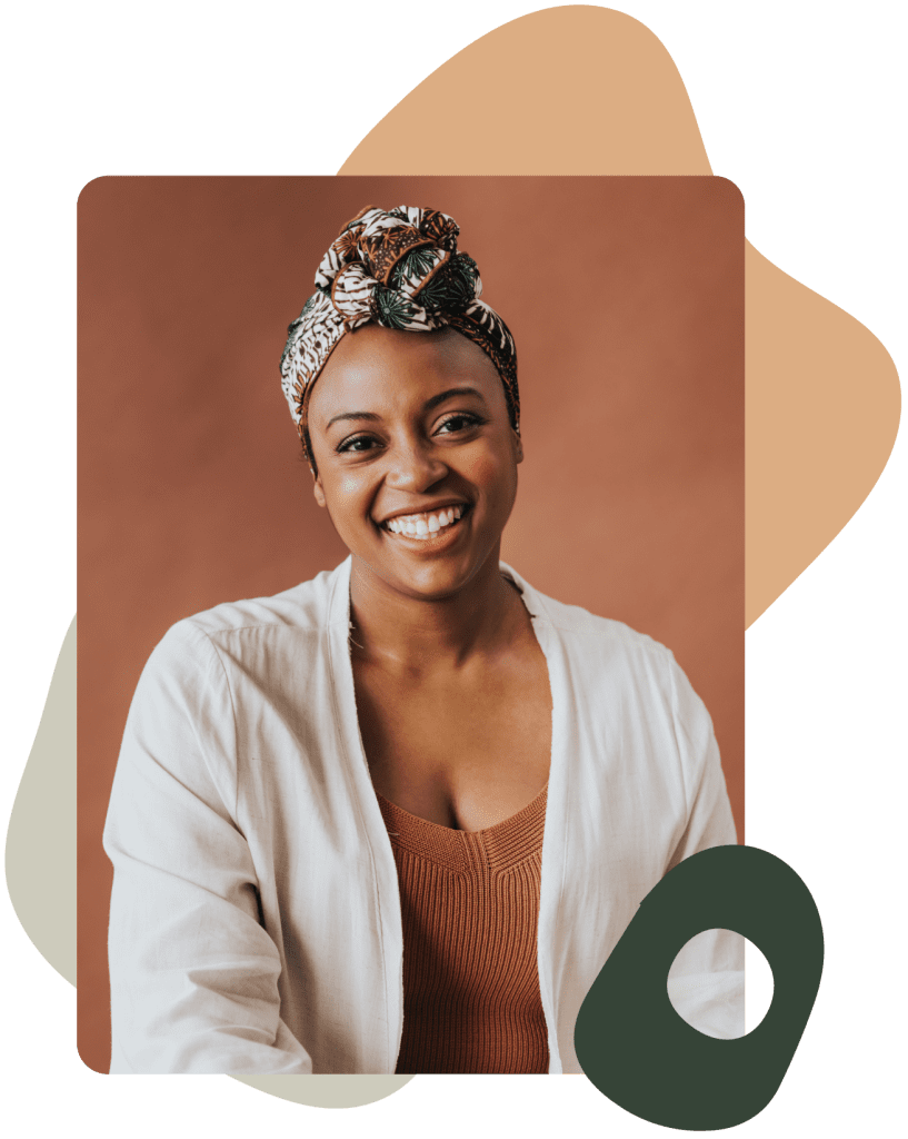 Jasmine Williams smiling in a white and orange top with a head scarf.